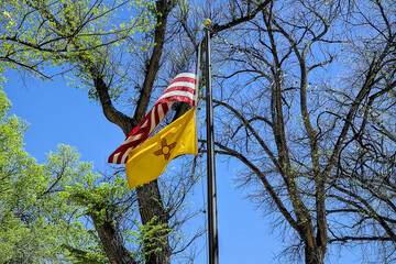 The flags of the United State and New Mexico fly proudly in the central plaza of Las Vegas, NM.