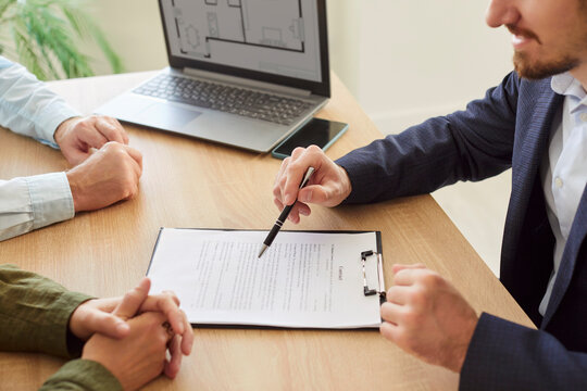 Real estate agent clients consulting broker about house plan, project selling, buying new flat terms, investment, meeting at laptop in office, couple discussing property plan with lawyer, solicitor - Powered by Adobe