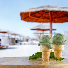 Ice cream on a wooden table by the beach – summer treat, dessert and seaside refreshment concept....