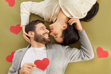 Family couple embracing and celebrates Valentine Day while holding a red heart. Their passion and...