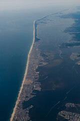 Coastal landscape along the shoreline viewed from above during overcast weather