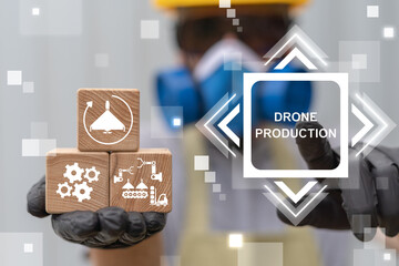 Industrial worker using virtual touch screen presses the inscription: DRONE PRODUCTION. Drone...