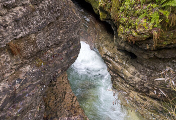the rapid flow of the mountain river in the canyon of the gorge during the autumn