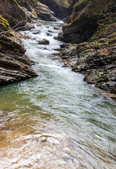 the rapid flow of the mountain river in the canyon of the gorge during the autumn