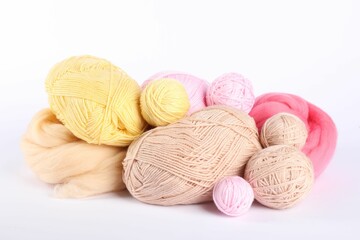 Felting wool and knitting yarn isolated on white