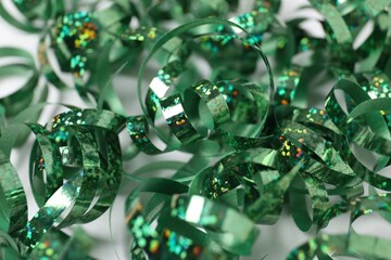 Shiny party streamers on white background, closeup