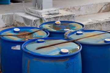 Weathered blue industrial storage drums