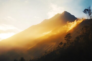 Fototapeta premium Golden hour sunlight illuminates majestic mountain peaks and wispy clouds