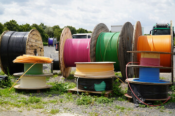 Big Rolls with colorful cable drums, fiber optic cables for faster Internet in rural region of...