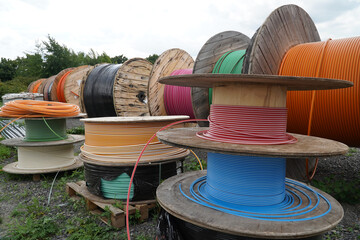 Big Rolls with colorful cable drums, fiber optic cables for faster Internet in rural region of...