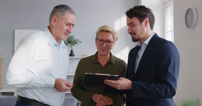 Young real estate agent, licensed professional lawyer, realtor speaking to senior, financial advisor giving consultation to elder, clients represent sellers, buyers of real estate, property 