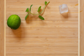 top view of cutting board, fresh lime and ginger on wooden board