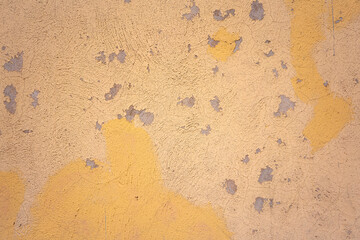 weathered yellow wall texture, peeling paint, old.