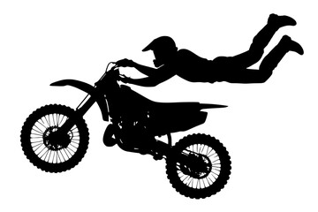 Silhouette of a motocross rider performing a stunt