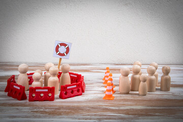 Social Protection and Exclusion Concept with Wooden Figures and Safety Symbol