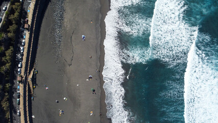 dramatic top down shot of black sand beach in tenerife