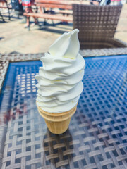 Ice cream cone on the table at summer time.