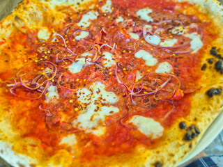 Detail of Neapolitan pizza with spicy salami.