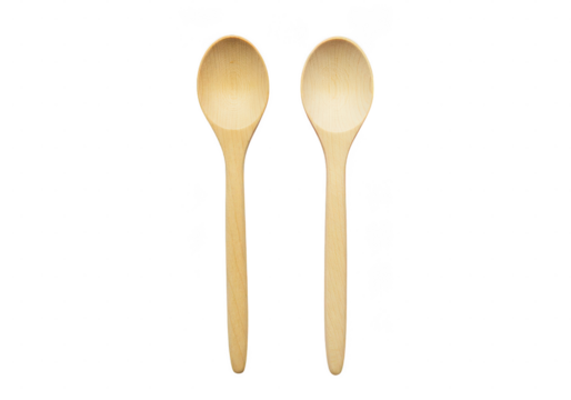 A close up of two wooden spoons aligned vertically on a dark plane surface in a studio setting on transparent background