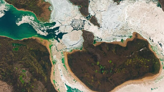 View from above on ice in sea waters near coast. Cold water concept. Camera is moving right and up. Animation based on image by NASA