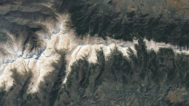 Aerial perspective on  mountain ridge covered with snow. Camera is zooming out, rotating clockwise. Animation based on image by NASA