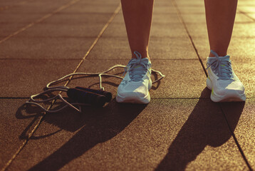 Woman in sneakers and a skipping rope