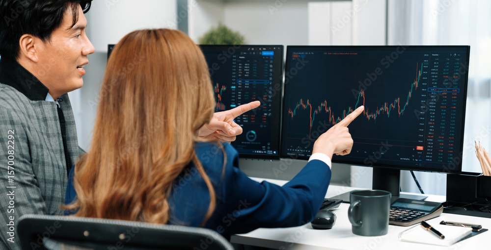 Poster panoramic photo asian business partners pointing to dynamic stock exchange data on computer screen v
