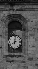 black and white church clock on a rainy day