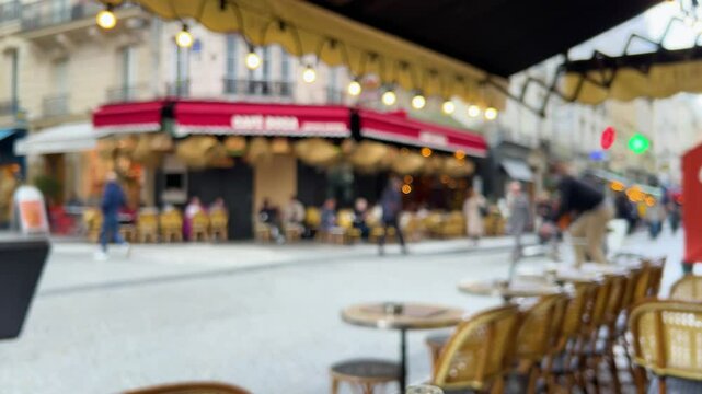 View of a busy Parisian pedestrian street with restaurants and shops in the trendy Marais district, Right Bank of the Seine River, Paris, France. Out of focus.