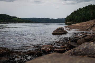 calm lake with forest and stones