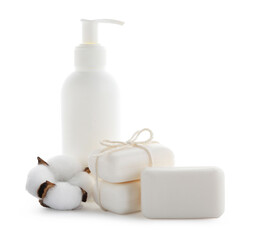 Soap bars, bottle of skincare product and cotton flower isolated on white