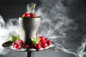 Hookah with cherries and smoke on black background, closeup. Space for text