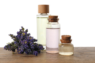 Natural essential oil and lavender flowers on wooden table against white background