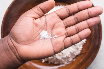 Overhead view of table salt in palm