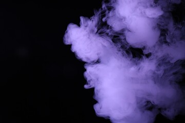 Hookah smoke in violet light on black background, closeup. Space for text