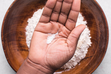 Overhead view of table salt in palm
