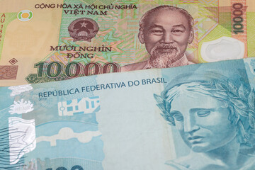 Fototapeta premium 10000 Vietnamese dong and 100 Brazilian real banknotes. International trade concept