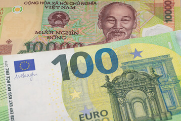 10000 Vietnamese dong and 100 euro banknotes. International trade concept