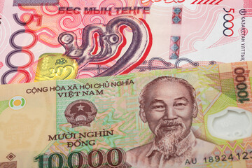 5000 Kazakhstani tenge and 10000 Vietnamese dongbanknotes. International trade concept