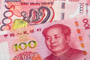 5000 Kazakhstani tenge and 100 Chinese renminbi (yuan) banknotes. International trade concept