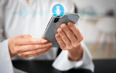 Young woman with mobile phone in office, closeup