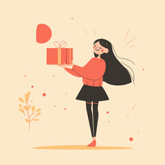 Cheerful girl holding a gift in autumn leaves