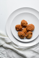 Overhead view of Akara on a white plate, top view of nigerian akara fried beans cake on a plate