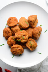 Overhead view of Akara on a white plate, top view of nigerian akara fried beans cake on a plate