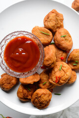 Overhead view of Akara on a white plate, top view of nigerian akara fried beans cake on a plate