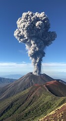 Volcano erupting with a large plume of smoke against a blue sky.