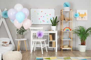 Interior of child's bedroom decorated for Birthday with balloons