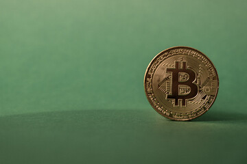 Golden Bitcoin coin in focus with