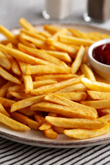 Homemade Golden French Fries with Ketchup, side view. Close-up.