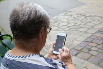 Senior woman using smartphone in the park